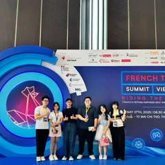 Six people in front of the French Tech Summit Vietnam backdrop, several giving a thumbs-up.